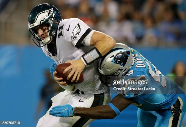 Thomas Davis of the Carolina Panthers tackles Carson Wentz of the Philadelphia Eagles during their game at Bank of America Stadium on October 12,...