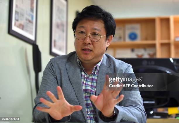 This picture taken on July 24, 2017 shows Kim Ho-Jin, CEO of Santa Cruise "digital laundry" company, speaking during an interview with AFP at his...