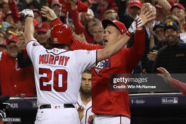 Daniel Murphy of the Washington Nationals celebrates with Adam Lind of the Washington Nationals after hitting a solo home run against the Chicago...