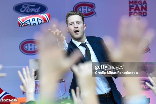 Ales Hemsky of the Montreal Canadiens tosses a shirt towards the fans prior to the NHL game against the Chicago Blackhawks at the Bell Centre on...