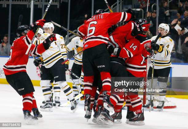 Olivier Garneau of the Quebec Remparts celebrates his game tying goal with his teammates against the Victoriaville Tigres during the third period of...