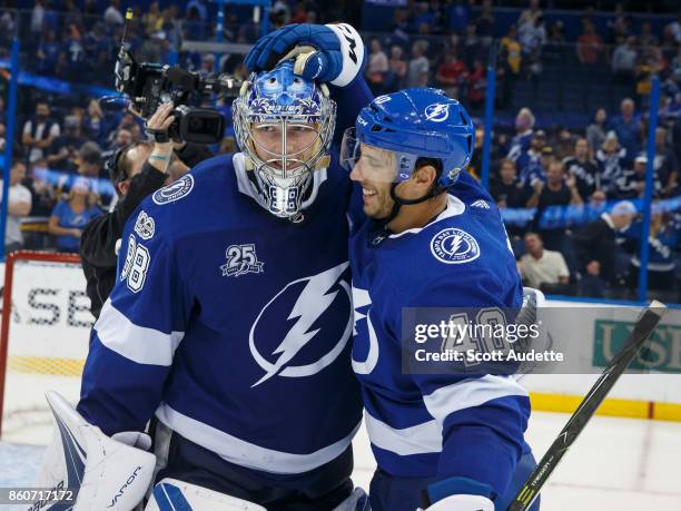 Goalie Andrei Vasilevskiy and Gabriel Dumont of the Tampa Bay Lightning celebrate the win against the Pittsburgh Penguins at Amalie Arena on October...