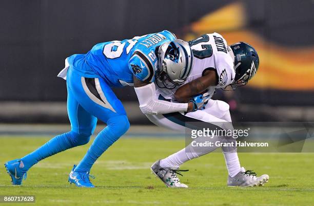 Daryl Worley of the Carolina Panthers tackles Torrey Smith of the Philadelphia Eagles in the first quarter during their game at Bank of America...