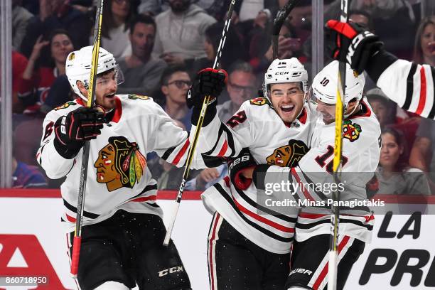 Alex DeBrincat of the Chicago Blackhawks celebrates his first period goal with teammates Michal Kempny and Patrick Sharp of the Chicago Blackhawks...