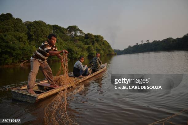 Fisherman Edmilson Ferreira places a net to fish arapaima, also known as pirarucu in the Western Amazon region near Volta do Bucho in the Ituxi...