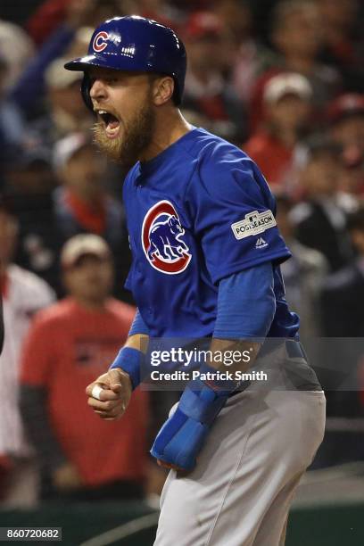 Ben Zobrist of the Chicago Cubs reacts after scoring on a double hit by Addison Russell of the Chicago Cubs against the Washington Nationals during...