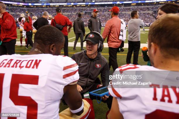 Wide Receivers/Passing Game Specialist Mike LaFleur of the San Francisco 49ers talks with Pierre Garcon and Trent Taylor on the sideline during the...