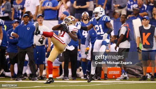 Marquise Goodwin of the San Francisco 49ers makes a reception as Vontae Davis of the Indianapolis Colts defends him, during the game at Lucas Oil...