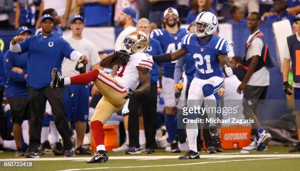 Marquise Goodwin of the San Francisco 49ers makes a reception as Vontae Davis of the Indianapolis Colts defends him, during the game at Lucas Oil...
