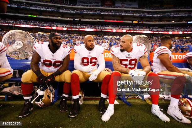 Earl Mitchell, Xavier Cooper and Aaron Lynch of the San Francisco 49ers talk on the bench during the game against the Indianapolis Colts at Lucas Oil...