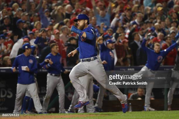 Ben Zobrist of the Chicago Cubs runs into home on a double hit by Addison Russell of the Chicago Cubs against the Washington Nationals during the...