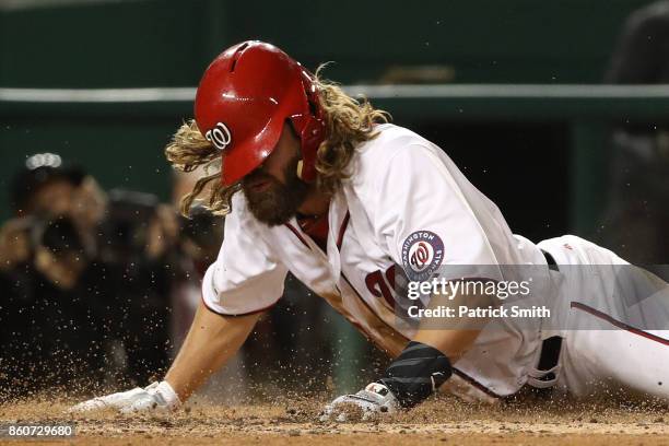 Jayson Werth of the Washington Nationals slides safelt into home against the Chicago Cubs during the sixth inning in game five of the National League...