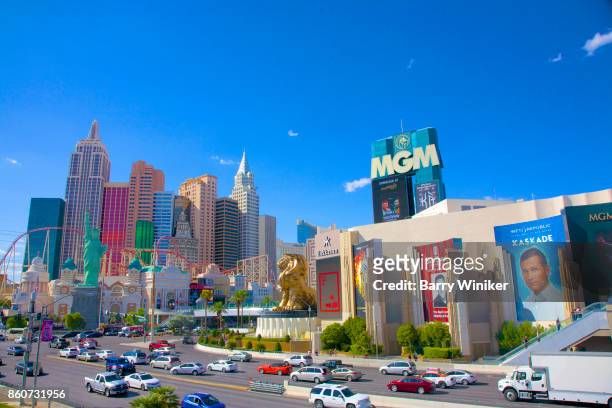 busy facades of mgm grand hotel and casino (at right) and new york - new york hotel and casino (at left) in las vegas - las vegas stock pictures, royalty-free photos & images