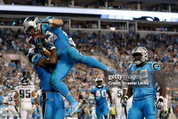 Christian McCaffrey celebrates with teammate Ed Dickson of the Carolina Panthers after a fourth quarter touchdown against the Philadelphia Eagles...