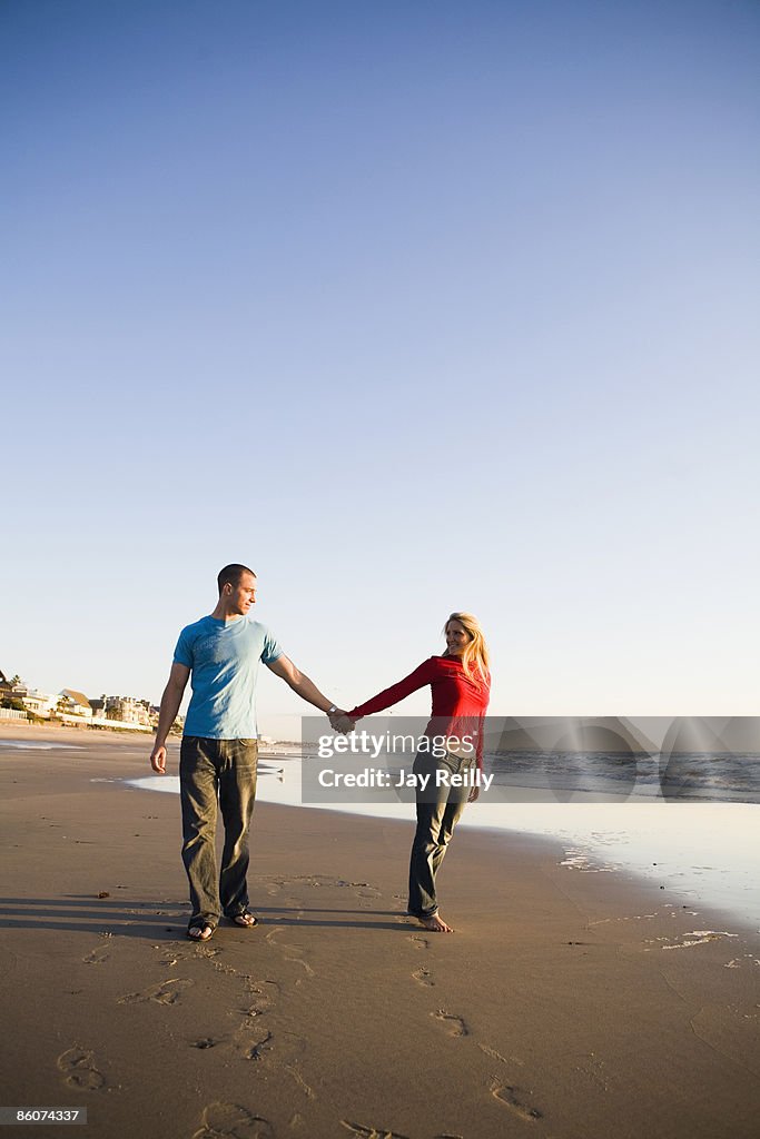 Couple holding hands on beach