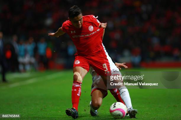 Alfonso Sanchez of Toluca struggle for the ball against Ernesto Alexis Vega of Toluca during the 13th round match between Toluca and Lobos BUAP as...