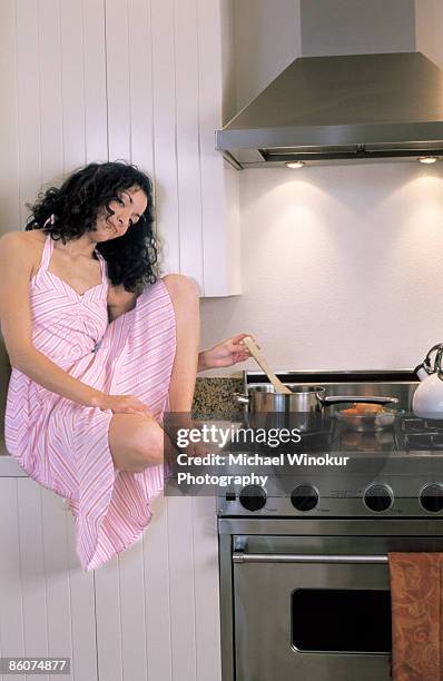 woman in kitchen cooking - bored housewife stock pictures, royalty-free photos & images