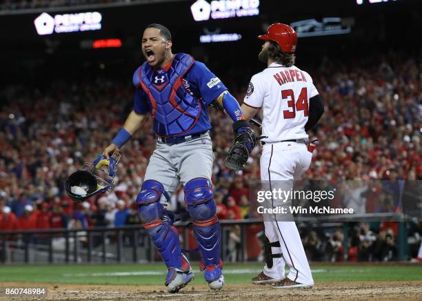 Willson Contreras of the Chicago Cubs celebrates next to Bryce Harper of the Washington Nationals after Harper struck out to end Game 5 of the...