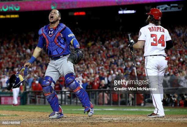 Willson Contreras of the Chicago Cubs celebrates next to Bryce Harper of the Washington Nationals after Harper struck out to end Game 5 of the...