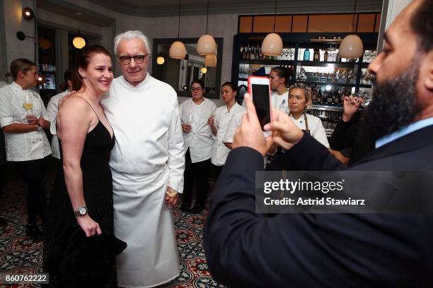 Chef Alain Ducasse poses for photos with guests during the celebration of women in the kitchen part of the Bank of America Dinner Series presented by...