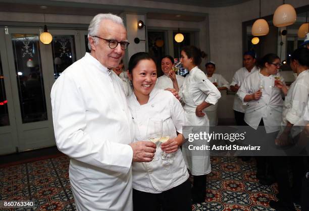 Chefs Alain Ducasse and Emily Yuen pose for photos during the celebration of women in the kitchen part of the Bank of America Dinner Series presented...