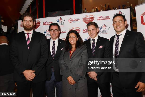 Rugbyman Pascal Pape poses with Anne Hidalgo and members of Le Stade Franais during the 'Boeuf A la Mode' Dinner Hosted by Les Artisans Bouchers de...