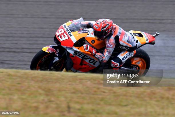 Honda rider Marc Marquez of Spain powers his machine during the second practice session of the MotoGP Japanese Grand Prix at Twin Ring Motegi circuit...