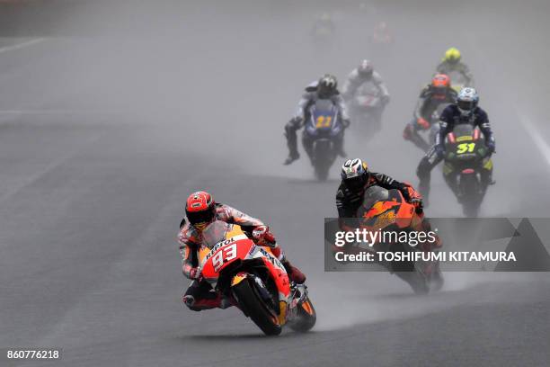 Honda rider Marc Marquez of Spain leads the pack into the first turn during the second practice session of the MotoGP Japanese Grand Prix at Twin...