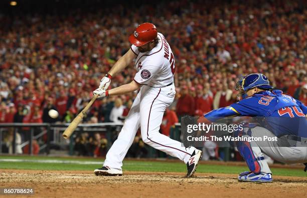 Washington Nationals second baseman Daniel Murphy hits an RBI double in the sixth inning against the Chicago Cubs during game five of the NLDS at...