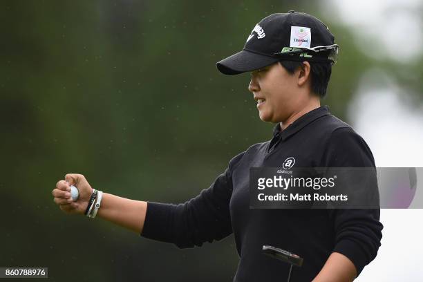 Hee-Kyung Bae of South Korea rects after her putt on the first green during the first round of the Fujitsu Ladies 2017 at the Tokyu Seven Hundred...