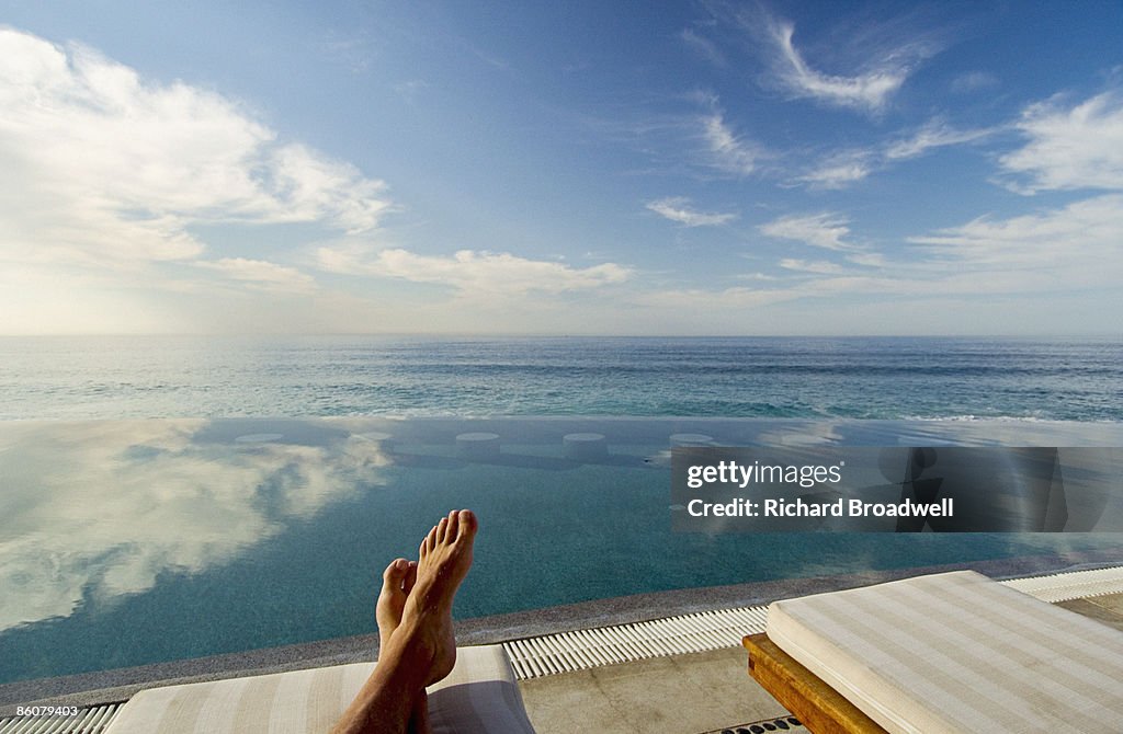 Feet relaxing by ocean