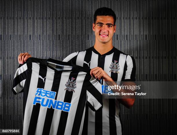 Mikel Merino poses for a photograph holding a home shirt after signing a permanent contract at the Newcastle United Training Centre on October 13 in...