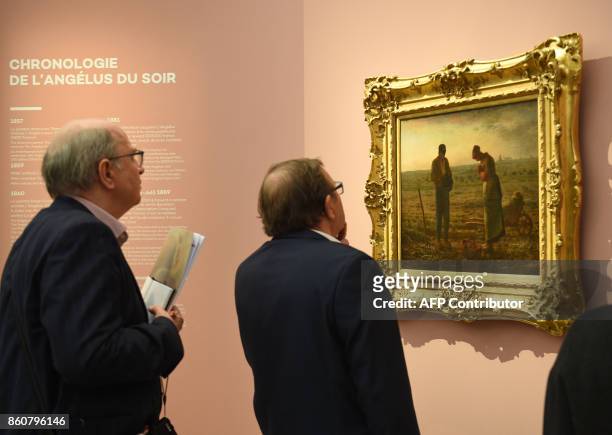 Visitors watch on October 12, 2017 the painting "The Angelus" by French 19th Century painter of the Realism art movement, Jean-François Millet,...