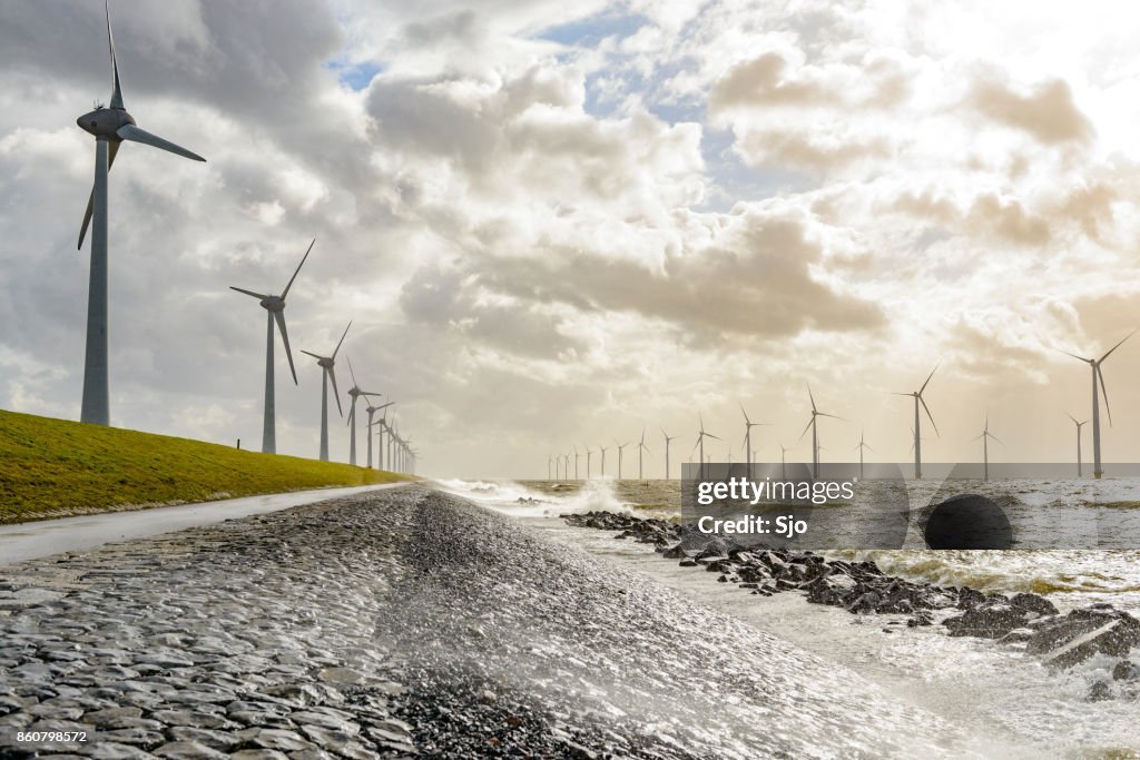 Wind turbines on land and offshore in a storm