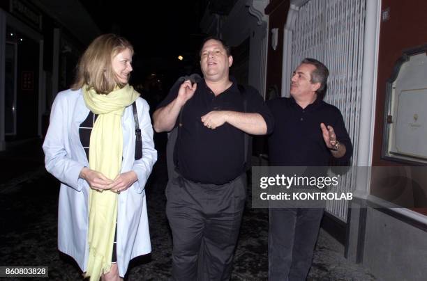 Aurelio De Laurentiis the President of soccer club Napoli, Harvey Weinstein, unidentified woman, walk on a Capri street.