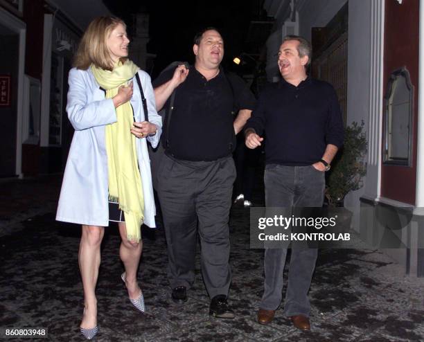 Aurelio De Laurentiis the President of soccer club Napoli, Harvey Weinstein, unidentified woman, walk on a Capri street.