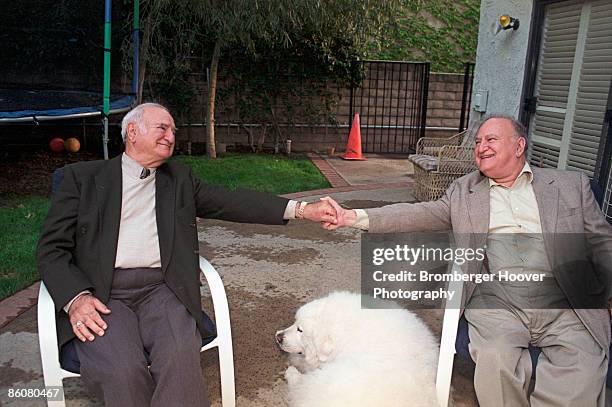 men holding hands - great pyrenees stock-fotos und bilder
