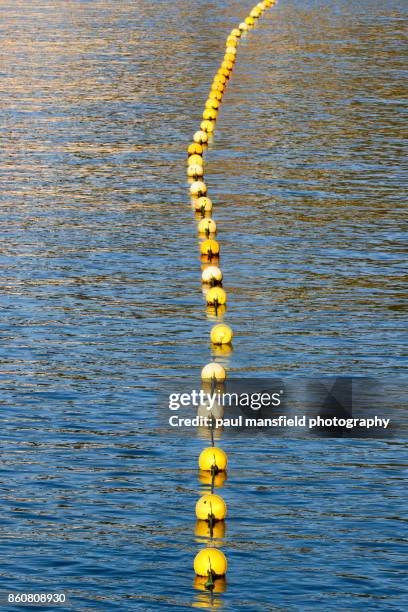 line of buoys in water - calella de palafrugell fotografías e imágenes de stock