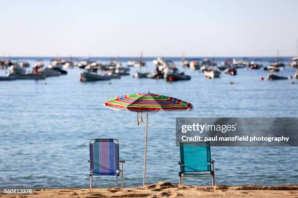 beach chairs and parasol at calella de palafrugell - calella de palafrugell fotografías e imágenes de stock