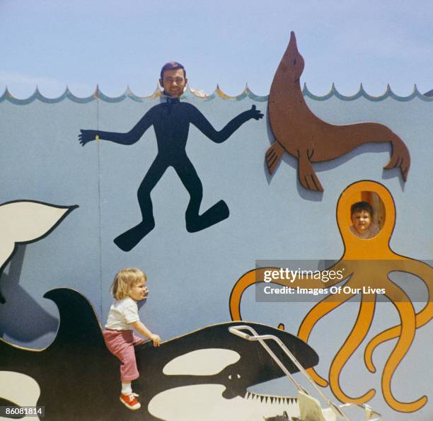 Family posing in amusement park cut-out