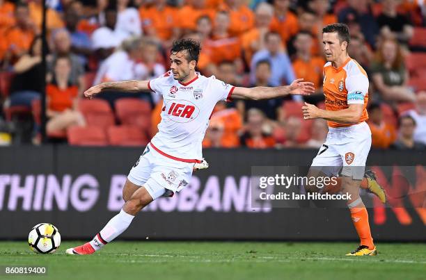 Nikola Mileusnic of Adelaide United makes a run past Matt McKay of the Roar during the round two A-League match between the Brisbane Roar and...