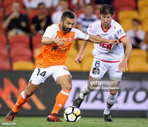 Fahid Ben Khalfallah of Brisbane and Vince Lia of Adelaide compete for the ball during the round two A-League match between the Brisbane Roar and...