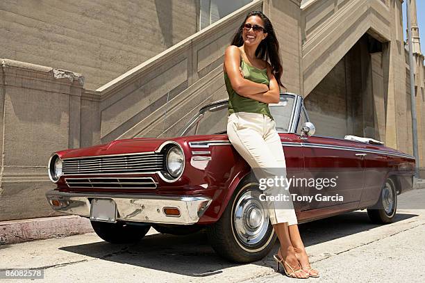woman standing next to vintage car - knäbyxor bildbanksfoton och bilder