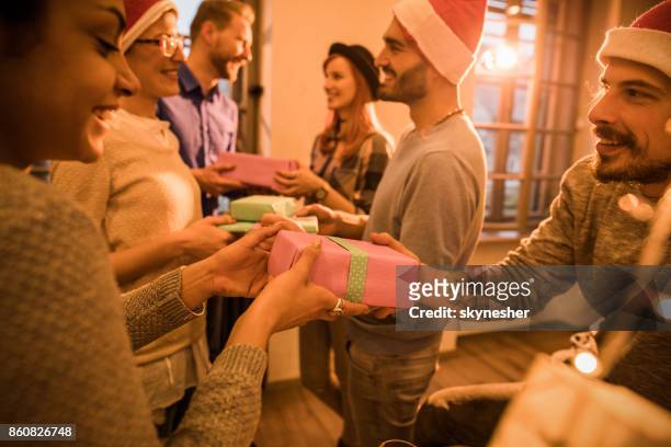 exchanging christmas gifts at office party! - christmas gift exchange stock pictures, royalty-free photos & images