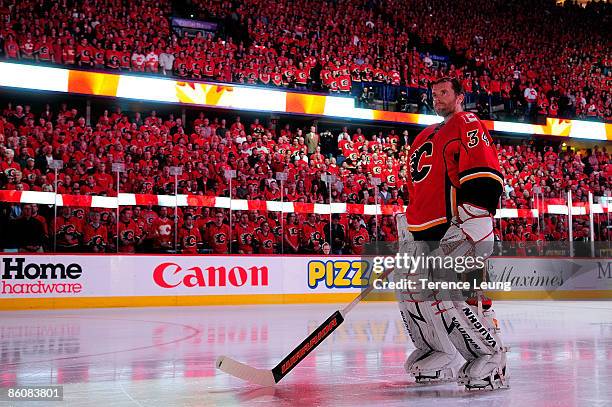 Miikka Kiprusoff of the Calgary Flames stands for the national anthem ceremonies amidst Calgary's C of Red against the Chicago Blackhawks during Game...