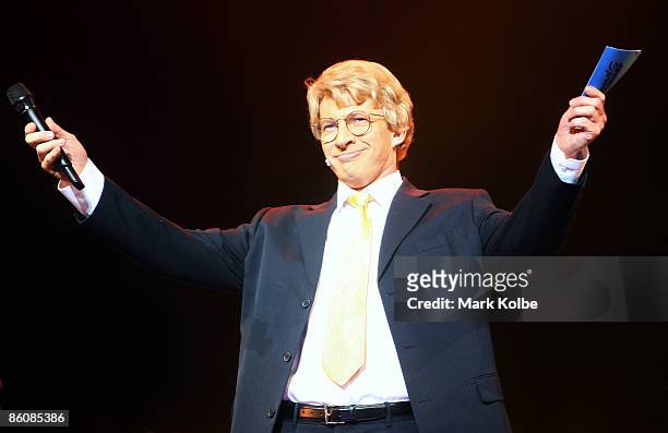 Actor David Wenham who plays Jerry Springer arrives on stage during the "Jerry Springer: The Opera" photocall at the Sydney Opera House in Sydney,...