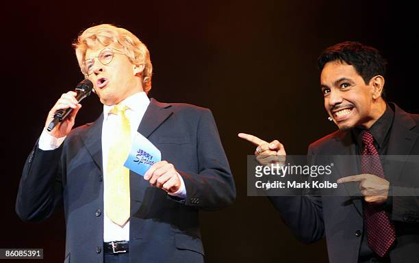 Actor David Wenham who plays Jerry Springer welcomes viewers to the show as actor David Bedella, who plays the warm-up man gestures toward him during...