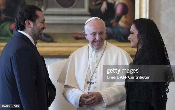 Pope Francis talks with Prime Minister of Lebanon Saad Hariri , and his wife Lara, during a private audience at the Vatican, on October 13, 2017. /...