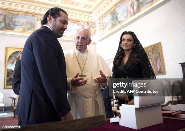 Pope Francis exchanges gifts with Prime Minister of Lebanon Saad Hariri , and his wife Lara, during a private audience at the Vatican, on October 13,...