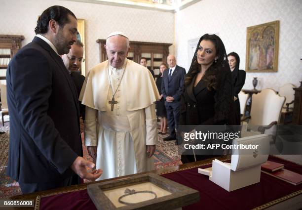 Pope Francis exchanges gifts with Prime Minister of Lebanon Saad Hariri , and his wife Lara, during a private audience at the Vatican, on October 13,...